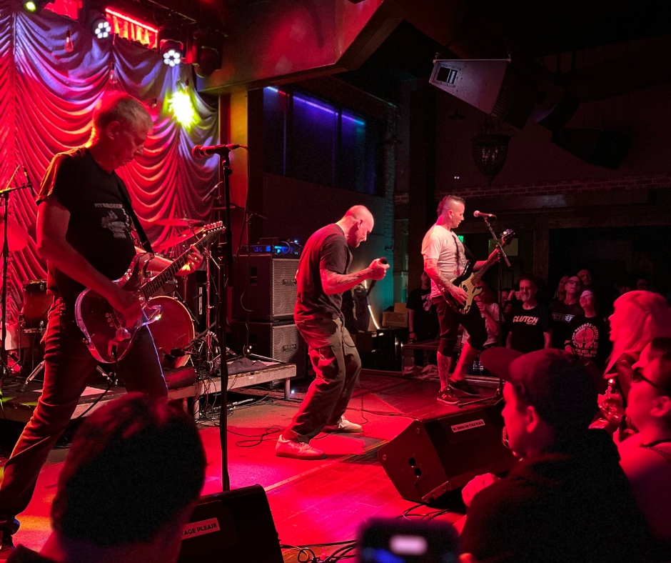 Side stage view of Black Flag performing live at Saint Rocke, capturing the band's intense energy